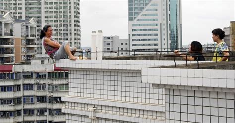 Woman Rescued During Suicide Attempt From Roof In China