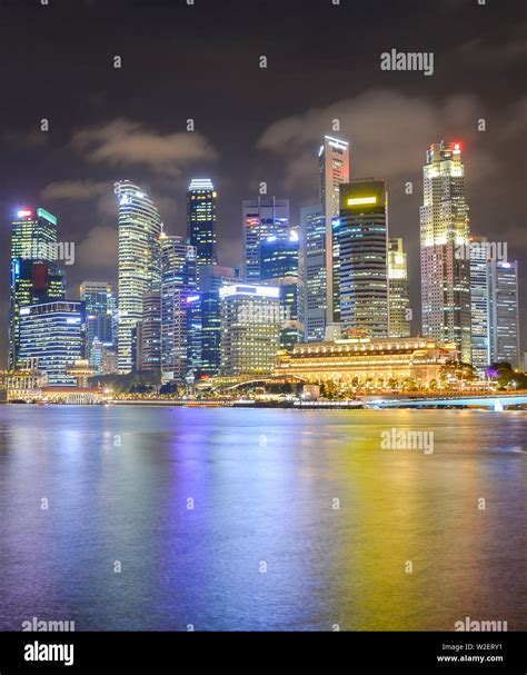 Illuminated Cityscape Of Singapore Downtown Core District With Colorful