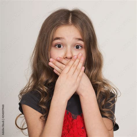 Shocked Little Girl Covering Her Mouth By Hands Stock Photo Adobe Stock