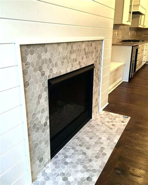 Fireplace tiles ideas this marble fireplace tile surround makes a large impact in a small space. Awesome Fireplace Tile Ideas #Fireplace #FireplaceTile # ...
