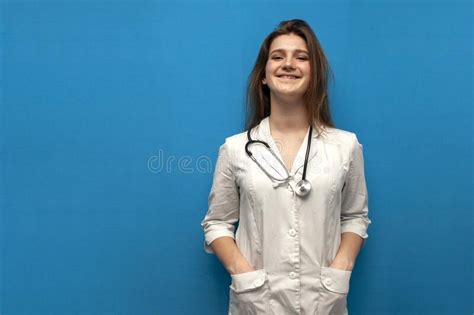 Portrait Of A Young Nurse On A Blue Background Girl Doctor In A White