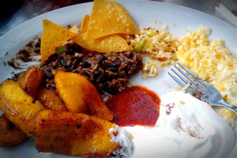 Breakfasts in el salvador typically include an assortment of salvadoran food, such as eggs scrambled with vegetables (huevos picados), cheese, fried plantains (platanos fritos), mashed beans, and tortillas. El Salvador Food: The Tastiest Dishes - AllTheRooms - The ...