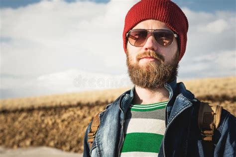 Portrait Of A Young Hipster Man Wearing Sunglasses And A Hat A Smiling