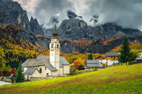Cute Alpine Village With Traditional Mountain Church Dolomites