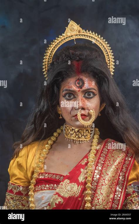 portrait of beautiful indian girl of durga idol agomoni concept indoor photo wearing traditional