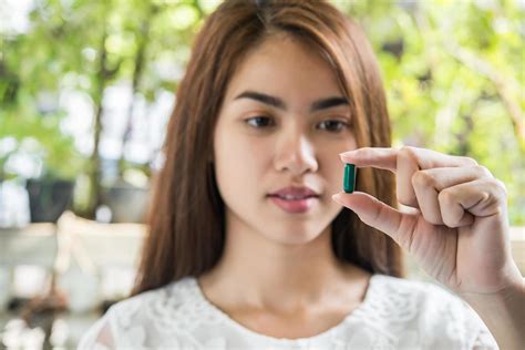 Woman Hand Holding A Pills Take Medicine According To The Doctors