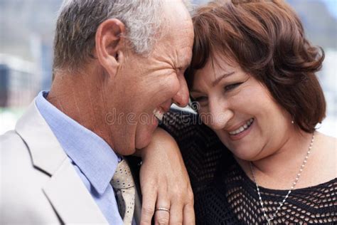 sharing a laugh closeup of a mature couple sharing an intimate happy moment together stock