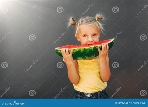 Funny Kid Eating Watermelon Outdoors On The Gray Backgrounds Stock