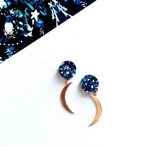 A glowing moon peeks through cascading foliage. Moon And Star Earrings By Mica Peet | notonthehighstreet.com