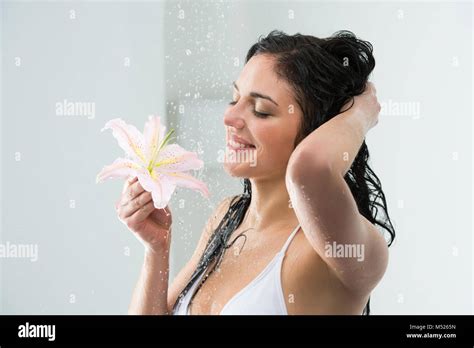 Woman Washing Herself While Showering With Happy Smile Lily Flower And Water Splashing