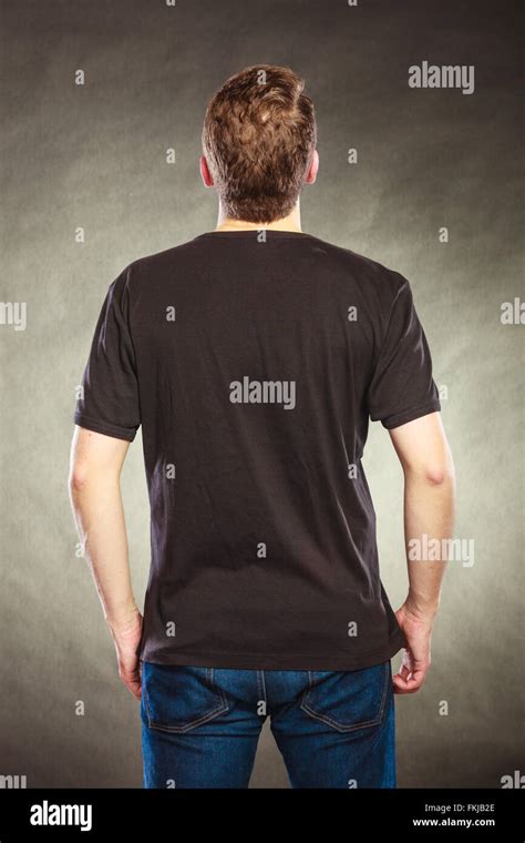 Back Rear View Of Fashionable Man In Black Blank Shirt With Empty Copy