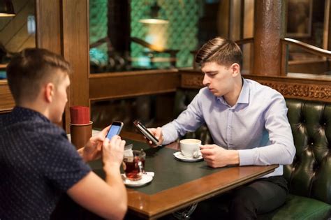 Free Photo Men Using Smartphones In Restaurant