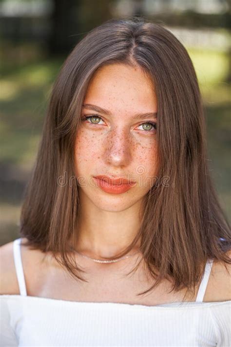 Young Beautiful Brown Haired Girl With Freckles On Her Face Stock Image