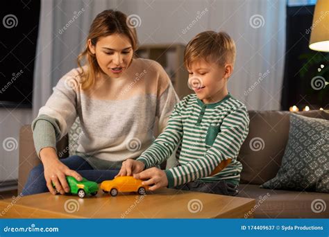Mother And Son Playing With Toy Cars At Home Stock Image Image Of