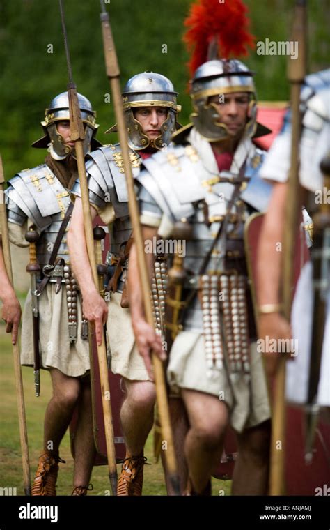 Roman Soldiers Marching With Shields And Weaponry At A Roman Army