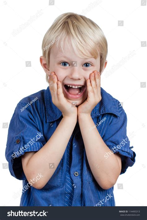 A Very Cute Young Boy Looking Surprised And Happy Looking At Camera