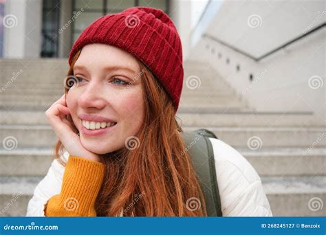 close up portrait of beautiful redhead girl in red hat urban woman with freckles and ginger