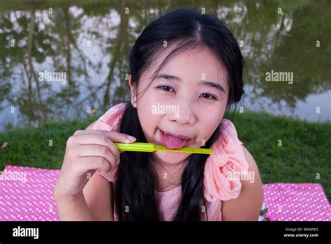 Asian Girl Is Licking Jam On Plastic Knife Stock Photo Alamy