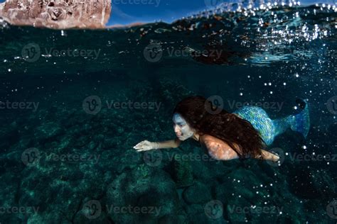 Mermaid Swimming Underwater In The Deep Blue Sea 20304669 Stock Photo