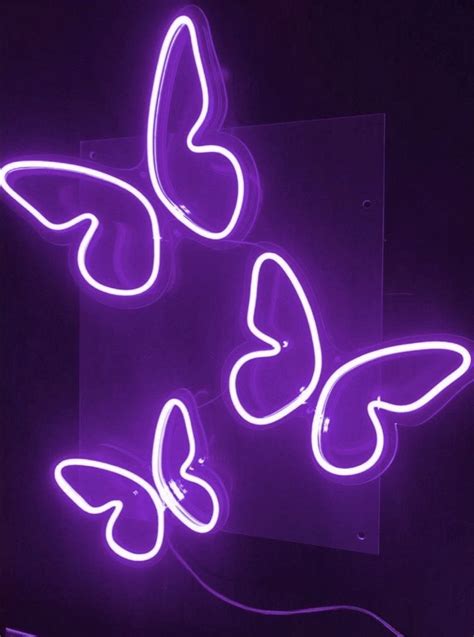 Three Neon Butterflies Are Glowing In The Dark One Is Purple And The
