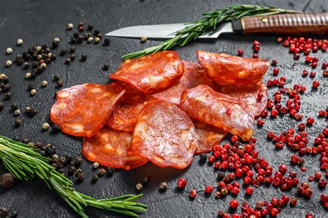 Spanish Sliced Chorizo Sausage Cured Meat Black Background Stock