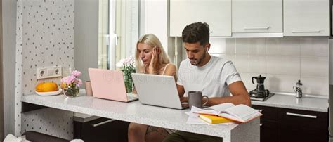 Young Multiethnic Couple Use And Work On Laptops Stock Photo Image Of