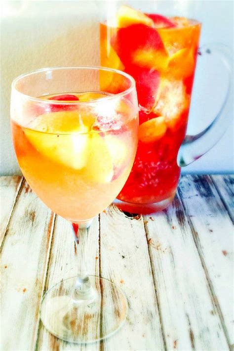 raspberry nectarine sangria with oranges and strawberries in the pitcher