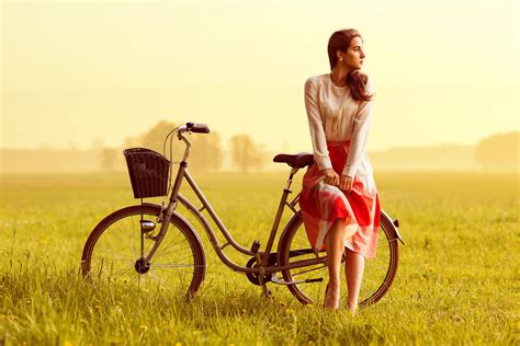 Обои на рабочий стол Девушка в красной юбке с платком в руках у велосипеда By Lasse Behnke