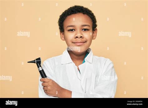 African American Boy With Otoscope On Beige Background Ear Treatment