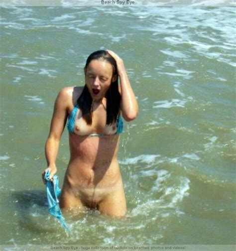 Lewd Babe Nudists Warms Naked Vagina In The Sun On A Wild Beach