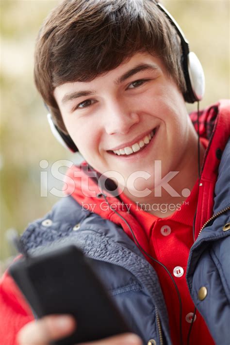 Teenage Boy Wearing Headphones And Listening To Music Stock Photo