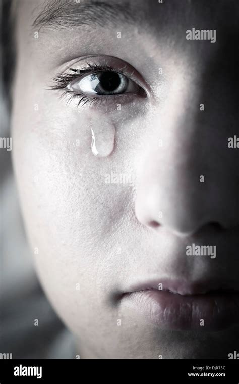 Closeup On Face Of Crying Girl With Tear Rolling Down Cheek Stock Photo