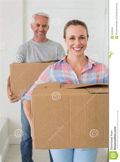 Happy Couple Carrying Cardboard Moving Boxes Stock Image Image Of