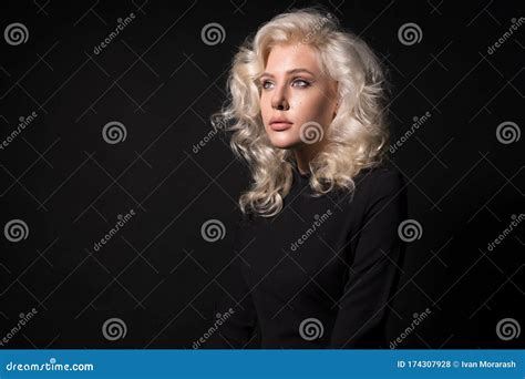 Dreamy Blonde Young Woman With Wavy Hair Isolated On Black Background