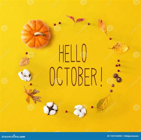 Hello October Message With Autumn Leaves And Orange Pumpkin Stock Photo