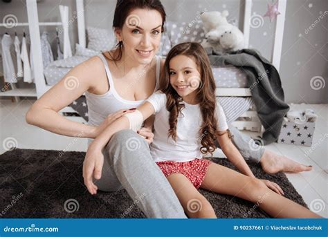 Playful Young Mother Teaching Daughter Medicine At Home Stock Image