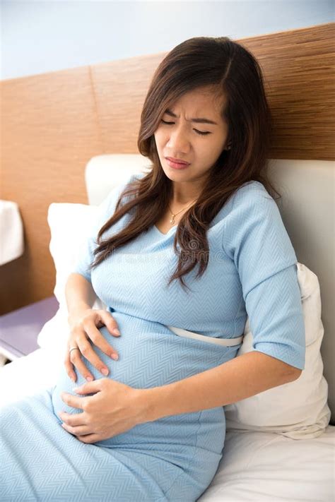 Asian Pregnant Woman Has Stomachache Sitting On Her Bed Stock Image Image Of Disease Medical