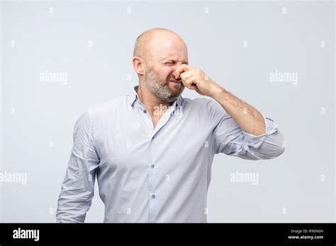 Stinky Smell Mature Man In Shirt Holding Nose Stock Photo Alamy