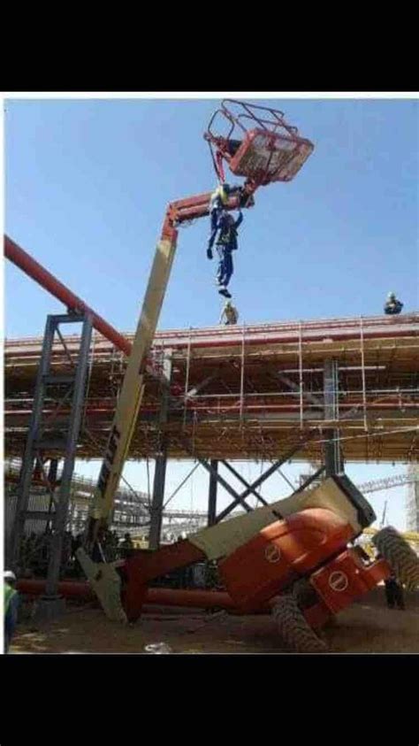 A Man On A Crane Working On A Construction Site