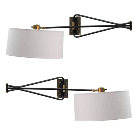 Hansen, in 1947 chrome wall mount plate, and has the original finials. Pair of French Swing Arm Sconces at 1stdibs