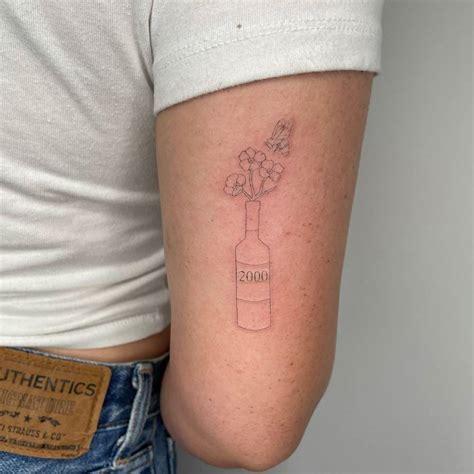 Single Neeele Flowers In A Bottle Tattoo