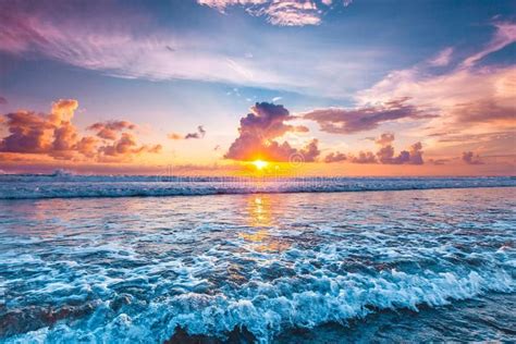 Sunset Over Ocean Splashing Ocean Wave In Front Of Beautiful Sunset
