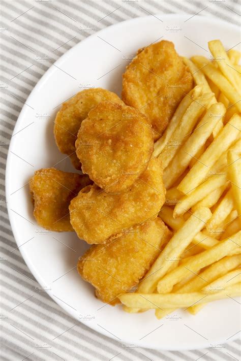 Tasty Fastfood Chicken Nuggets And French Fries On A Plate On C