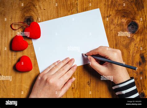 Woman Writing Love Letter Or Romantic Poem For Valentines Day Top View