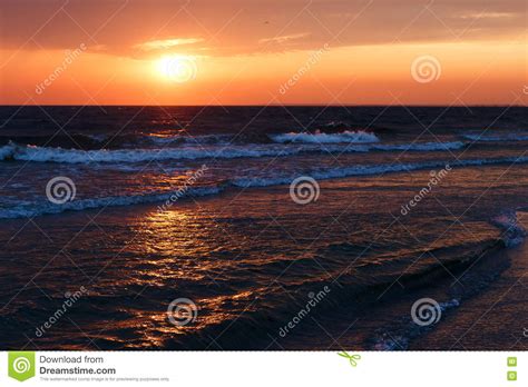 Beautiful Golden Sunset In The Sea With Saturated Sky And Clouds