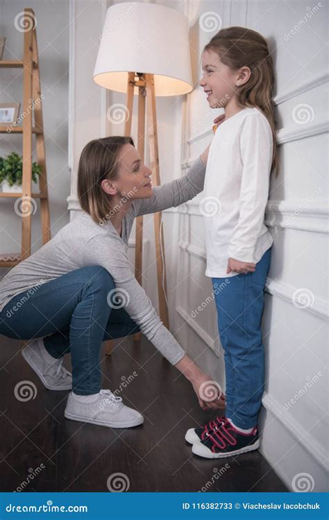Alert Mother Measuring Her Daughters Height Stock Image Image Of