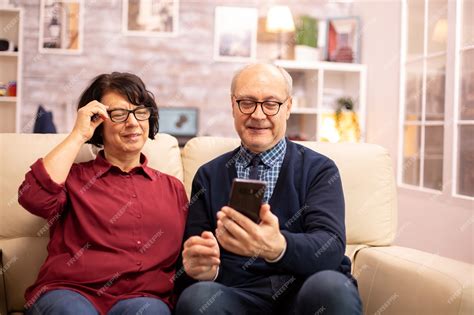 Premium Photo Beautiful Elderly Couple Taking A Selfie While Sitting On The Couch In The