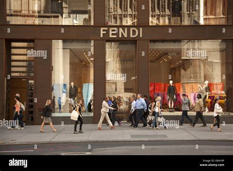 People Walk Along 5th Ave In Midtown Manhattan Past Many International