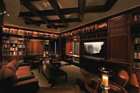 62 Home Library Design Ideas With Stunning Visual Effect A living room set up in the home's basement, featuring leather seats set on the carpet.