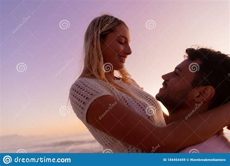 Caucasian Couple Enjoying Time At The Beach During The Sunset Stock Image Image Of Woman